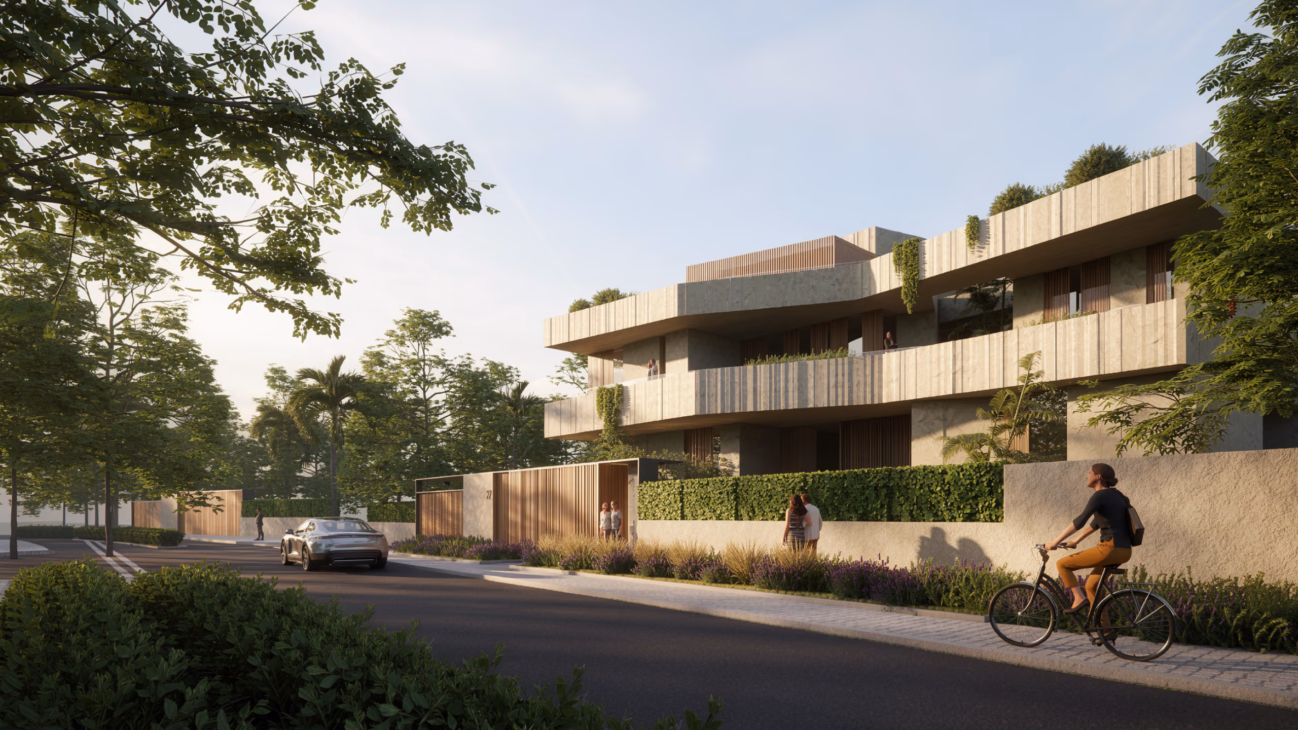 Street view of Geode villa in Dubai, tiered stone-textured terraces with timber screens above a hedge-lined wall, pedestrians and a cyclist passing by