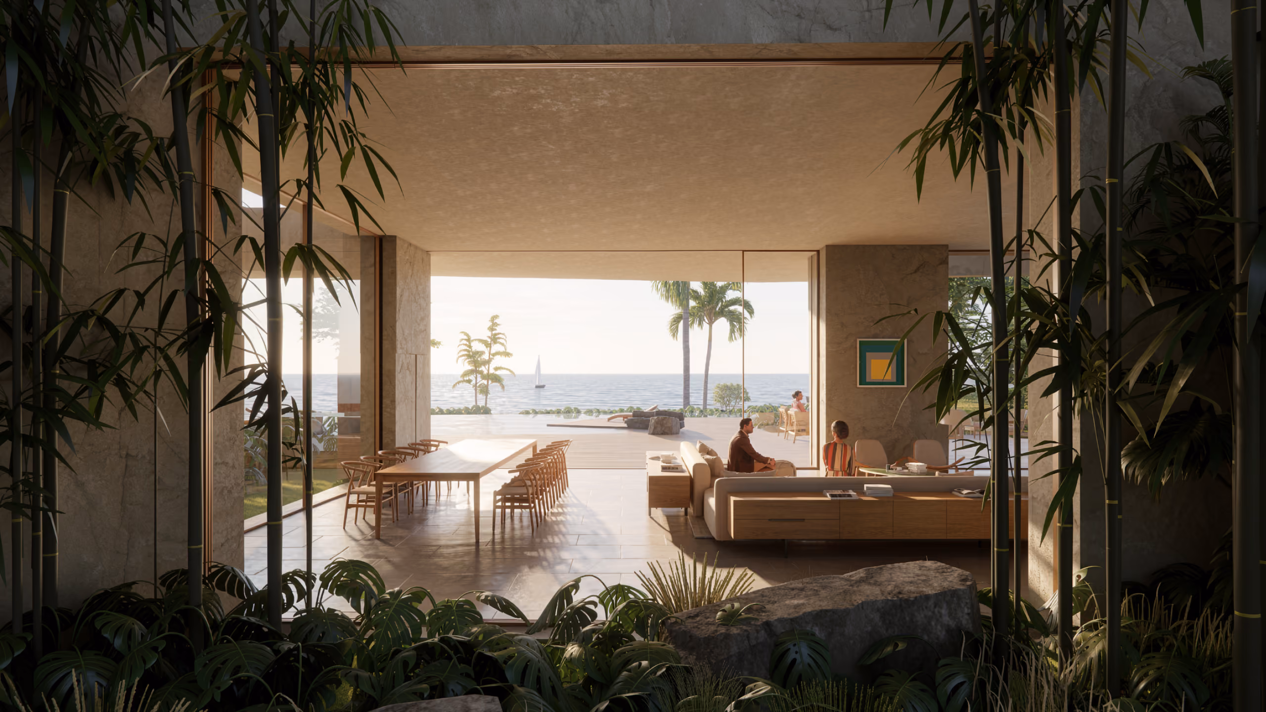 Framed through bamboo and boulders at Geode villa in Dubai, an open living and dining area facing the sea, with figures seated among low sofas