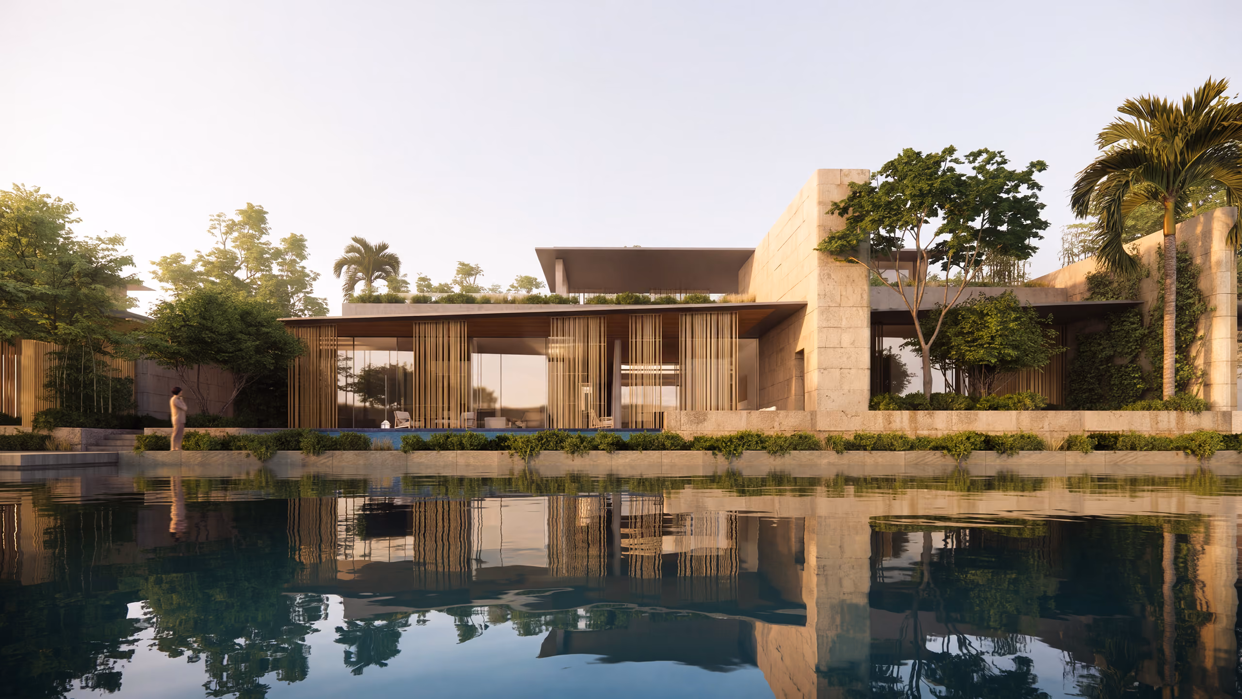 Beach Club Villas in Dubai, stone-walled villa with timber slat screens reflected in the Tilal Al Ghaf Lagoon at dusk, framed by palm trees
