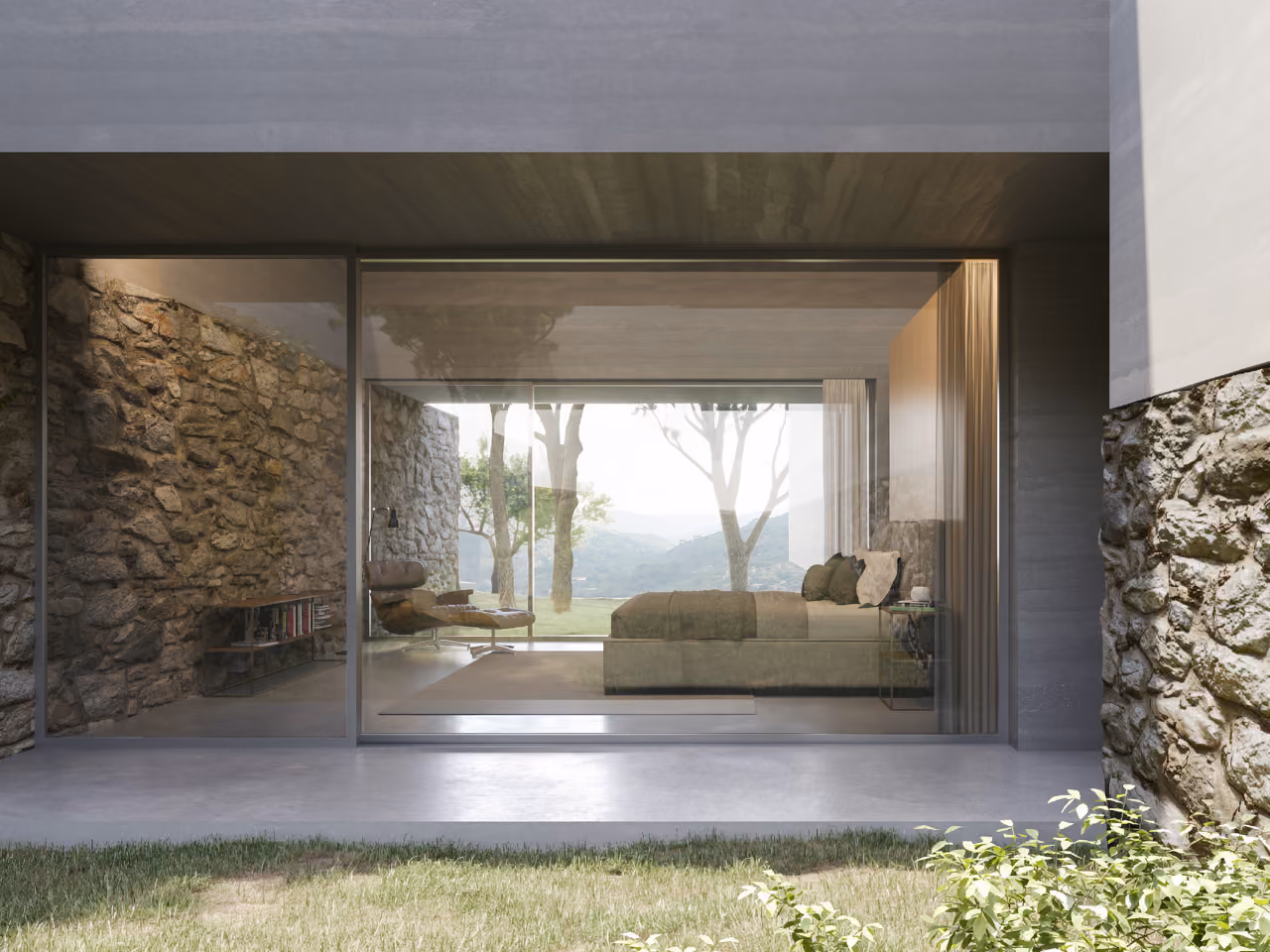 Bedroom of YM House in Deir el Qamar opening through a full-height glass wall onto a stone-clad terrace framed by trees and hills