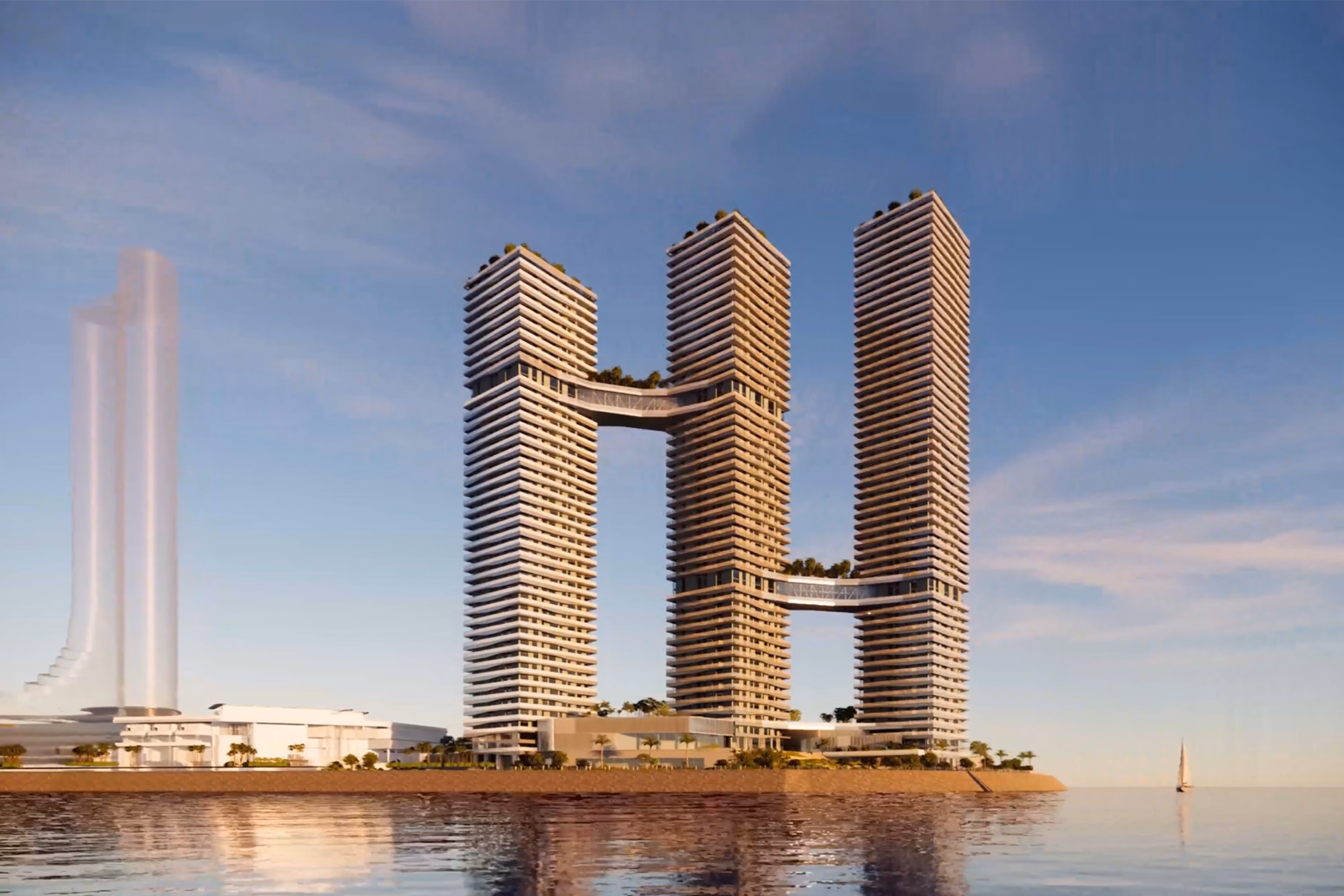 Trilliant, three connected high-rise towers linked by sky bridges by Nabil Gholam Architects, standing on the Dubai waterfront under a clear sky