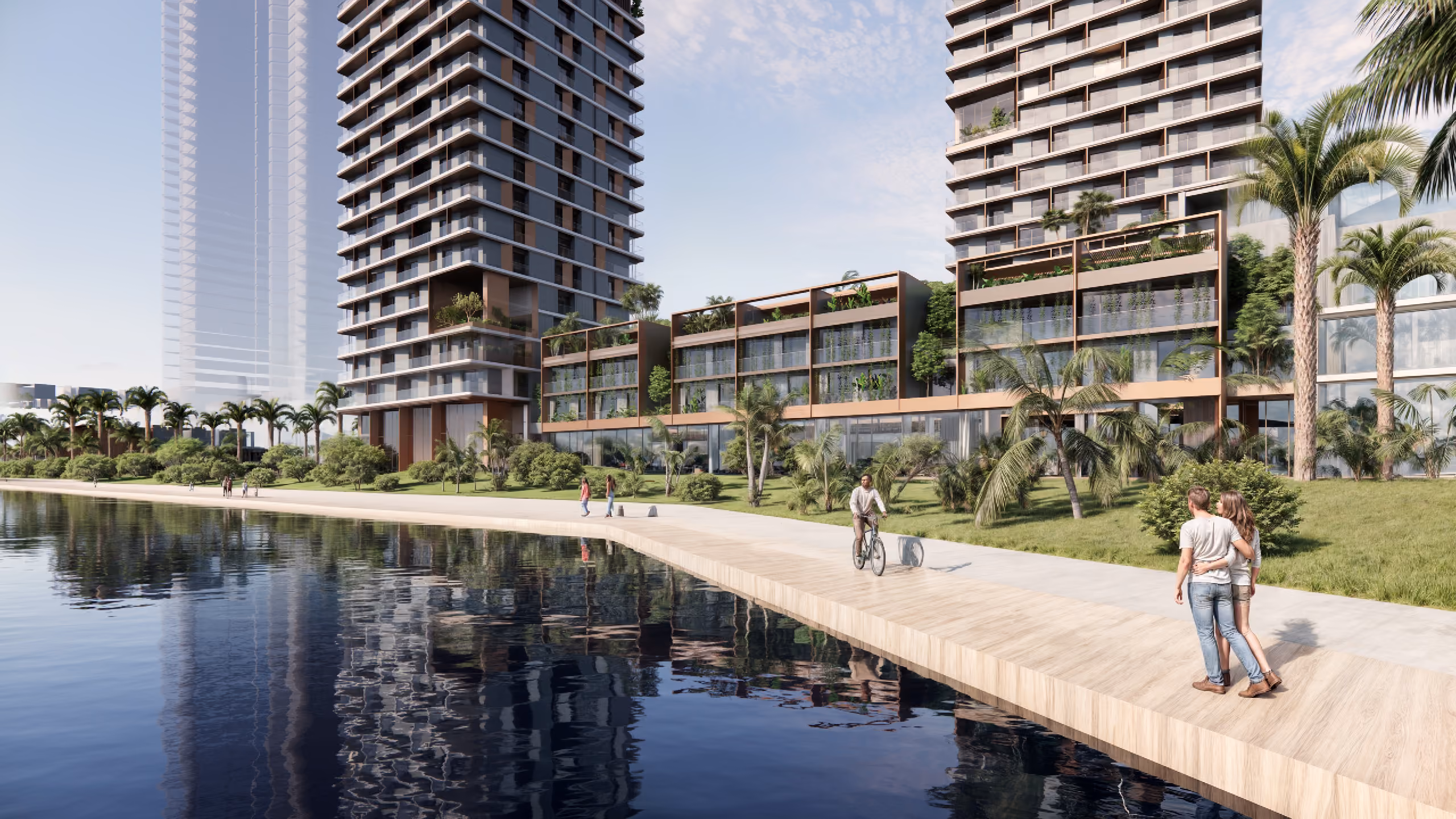 Waterfront promenade at Orise in Dubai, twin residential towers with landscaped podium, palm trees and pedestrians beside a calm canal