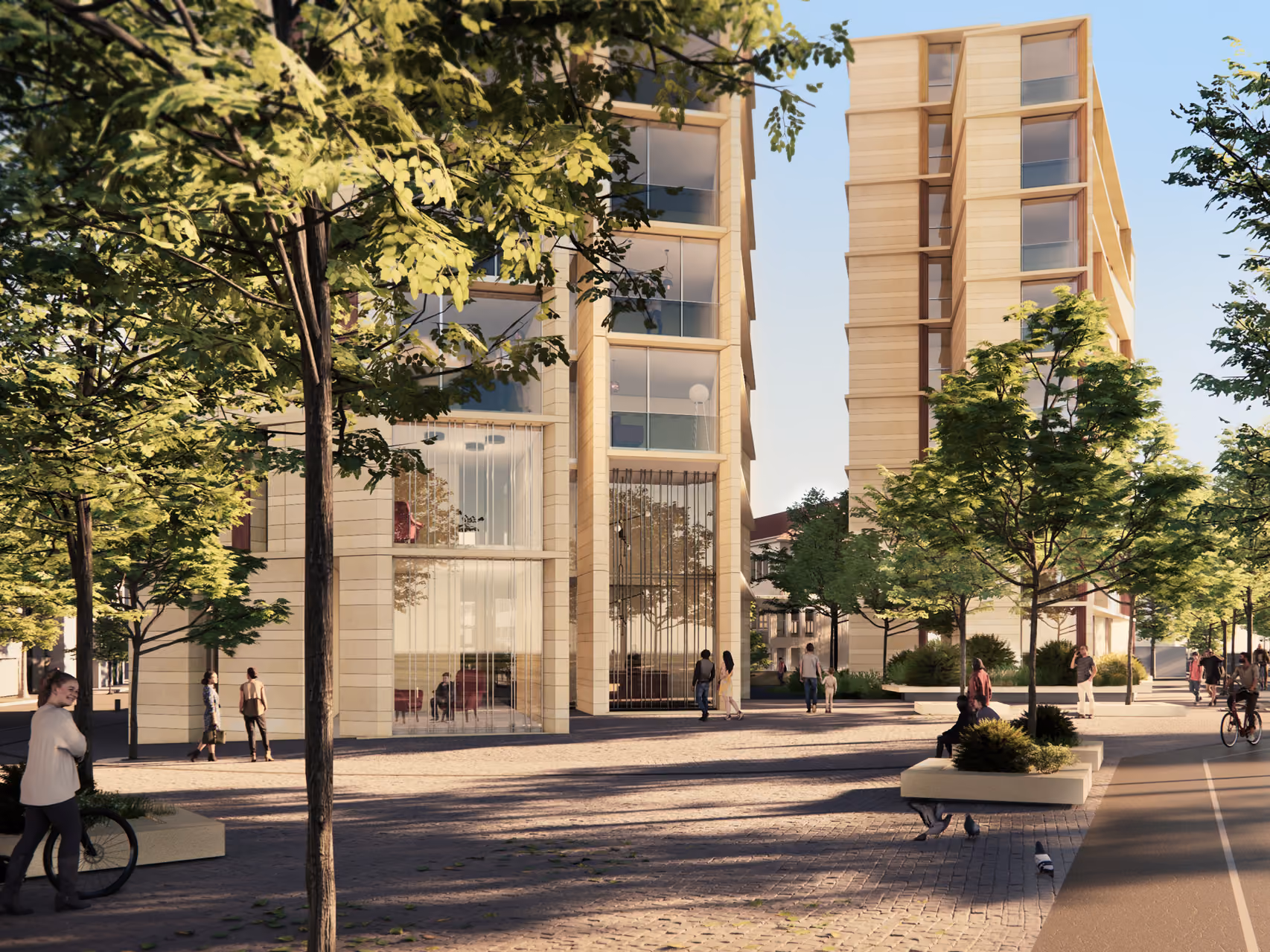 Street-level view of Tour de Nice in Nice, stone-clad tower volumes with recessed glazing, pedestrians and cyclists on a tree-lined plaza