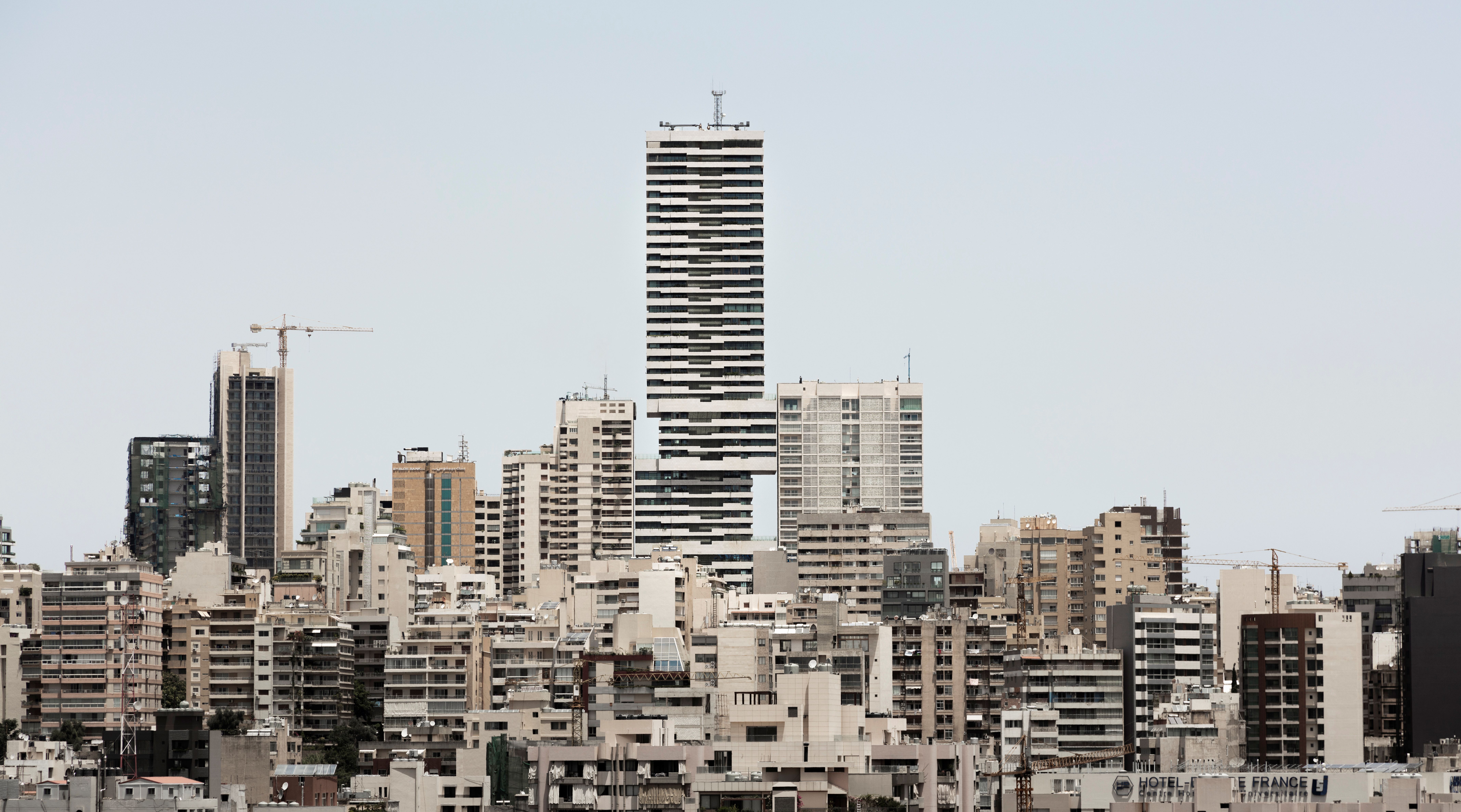 Skygate, a striated high-rise by Nabil Gholam Architects formed of four stacked cubical volumes, towering above Beirut's dense skyline, Lebanon