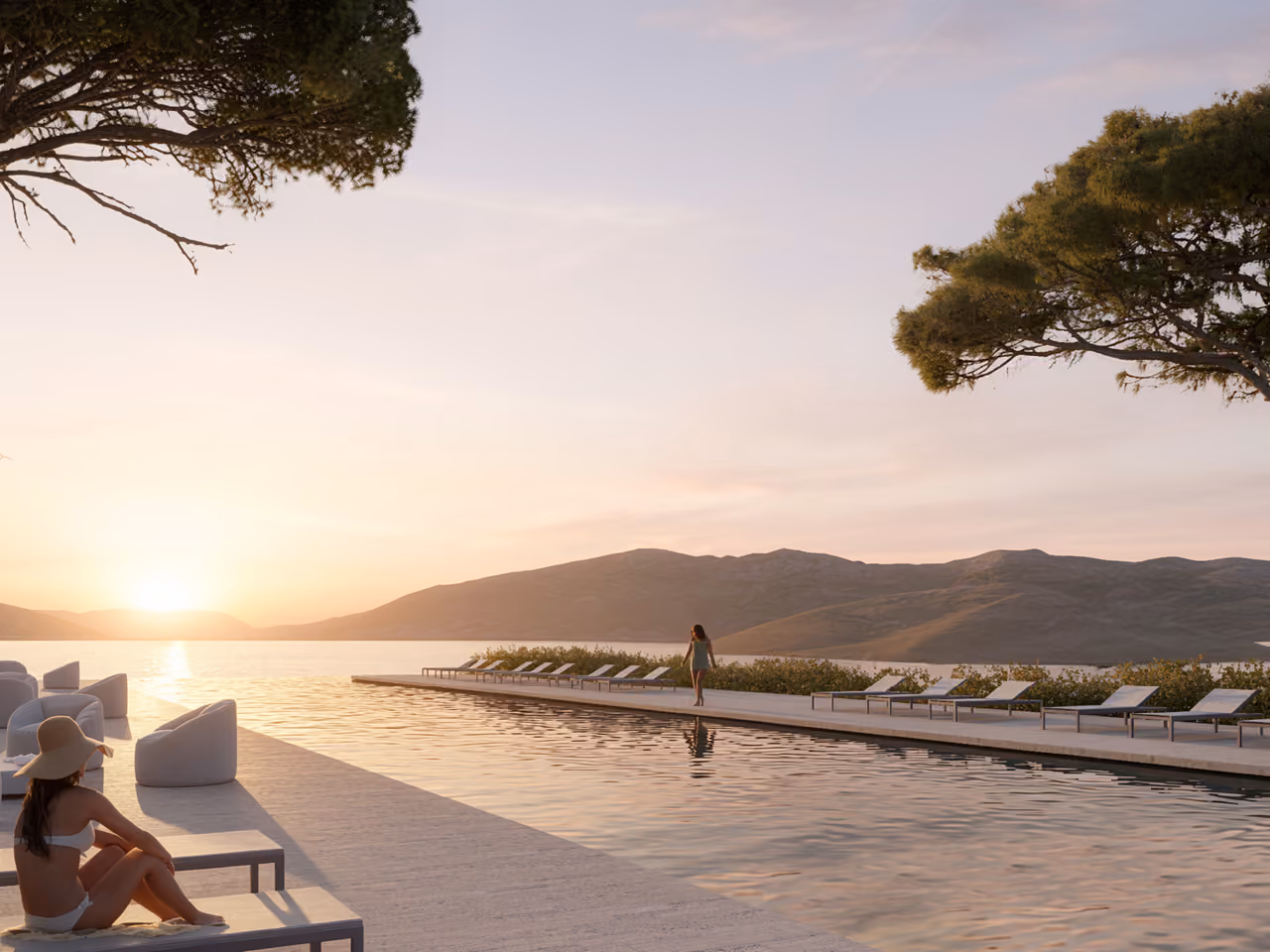 Infinity pool at Tivat Hotel and Beach Resort in Tivat, loungers along the water's edge and figures relaxing at sunset with mountains beyond