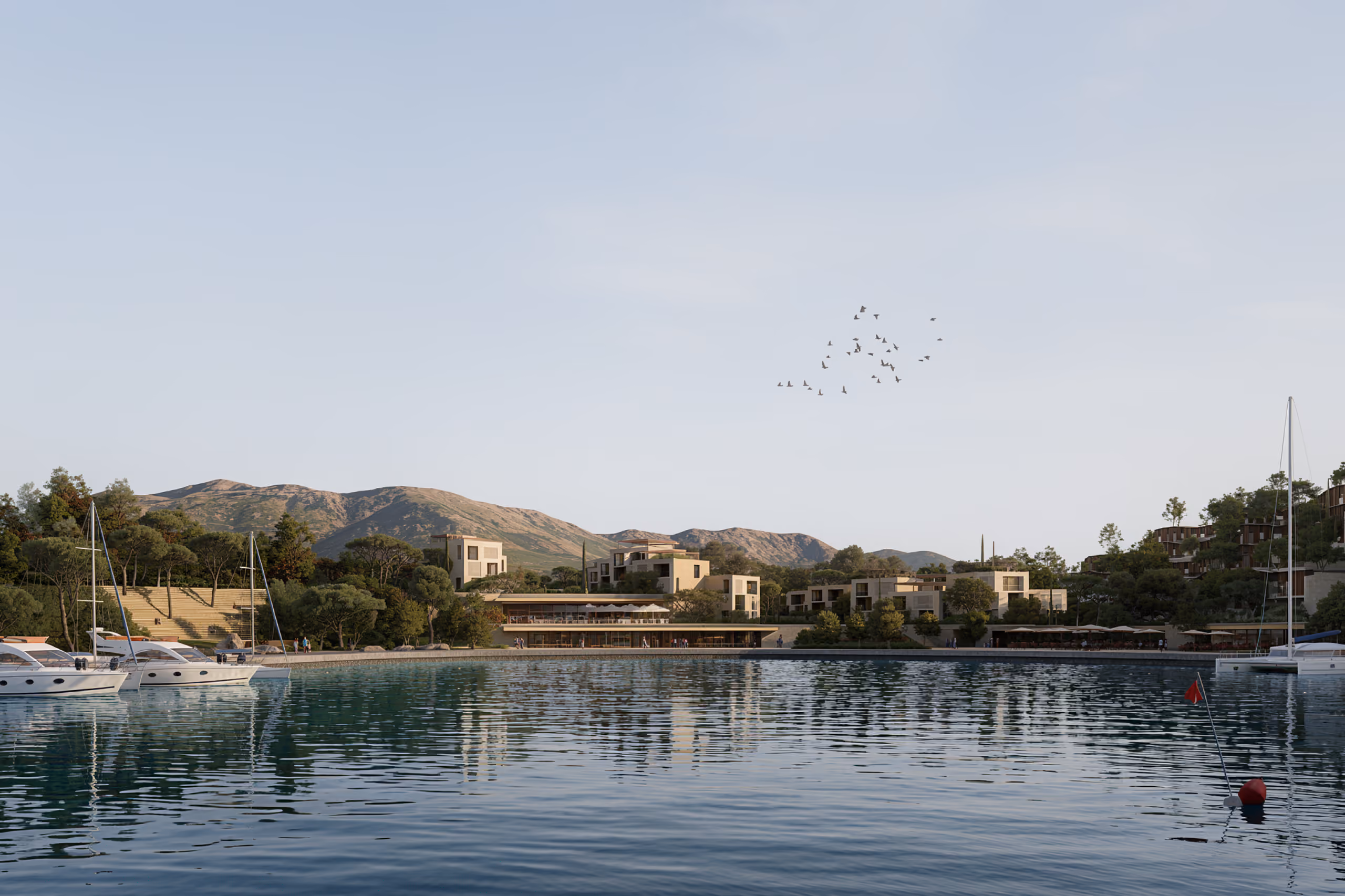 Waterfront view of Tivat Hotel and Beach Resort in Montenegro, low-rise buildings along the bay backed by hills, with yachts moored in the marina