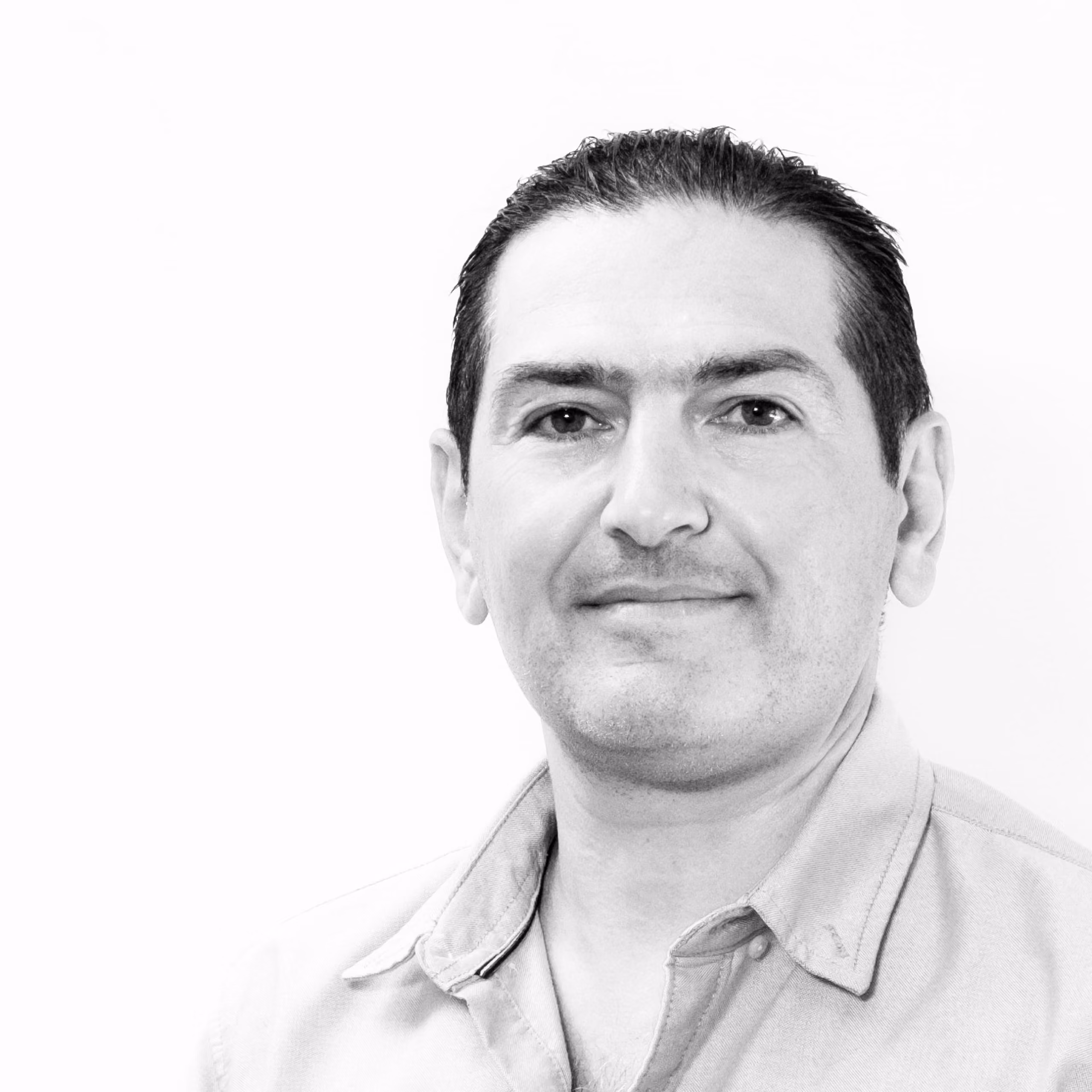 Marwan Khabbaz, Assistant at Nabil Gholam Architects, black and white portrait with short dark hair wearing an open-collared shirt