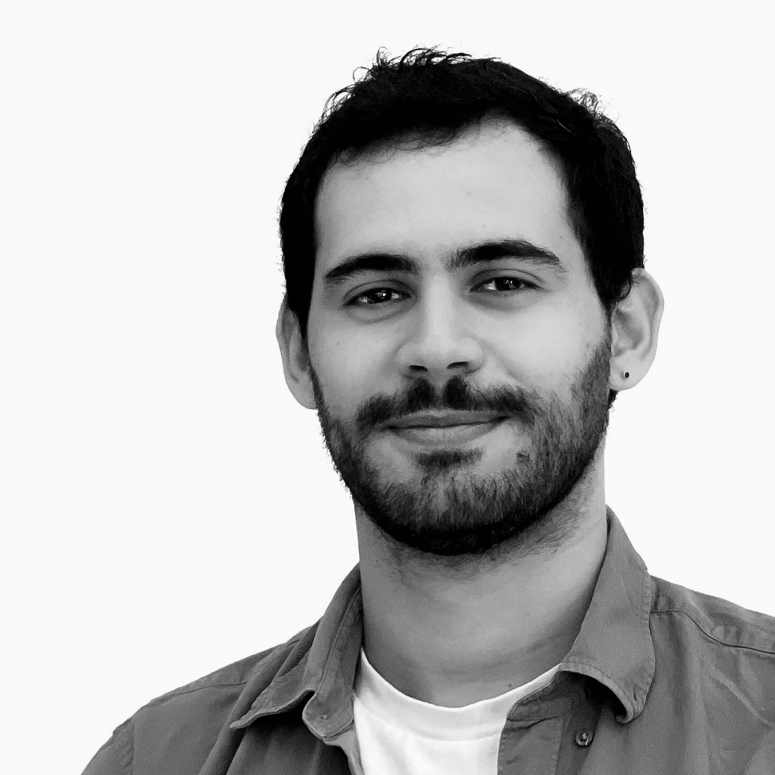 François Nour, Architect at Nabil Gholam Architects, black and white portrait smiling with a beard and collared shirt
