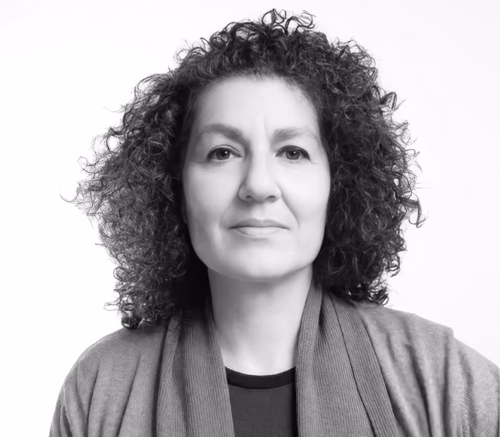 Joumana Arida, Senior Architect and Head of Communication at Nabil Gholam Architects, black and white portrait with curly hair and a draped cardigan