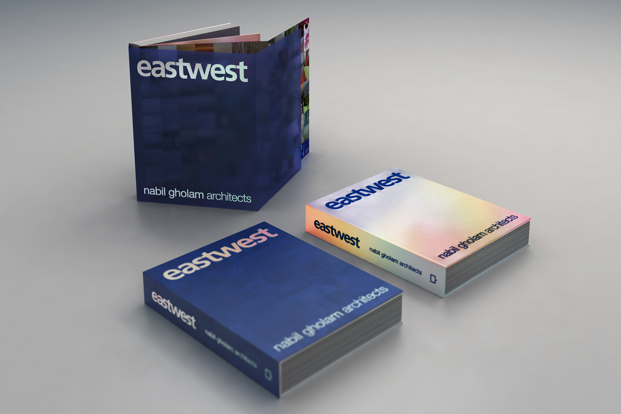 Three stacked copies of Eastwest, a Nabil Gholam Architects monograph, shown in dark blue and gradient rainbow cover editions standing upright and lying flat