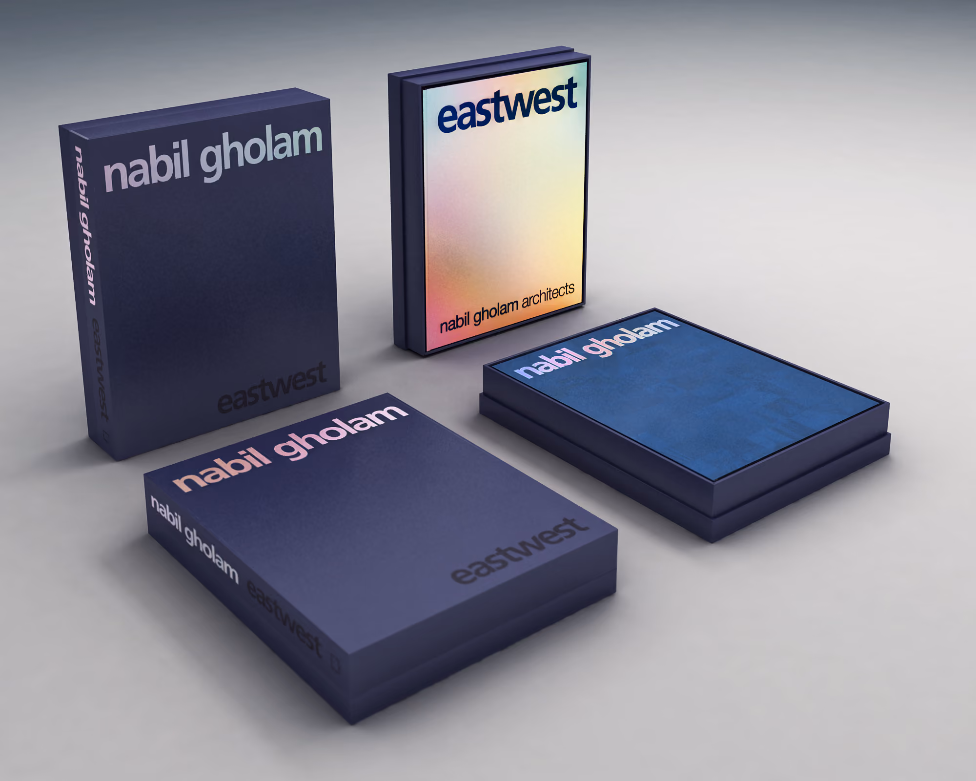 Mock-up of Eastwest publication by Nabil Gholam Architects, dark blue slipcase and hardcover editions with an iridescent dust jacket, arranged on a grey surface