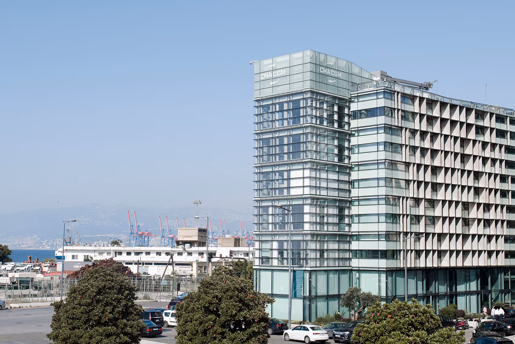 CMA CGM Headquarters in Beirut, its glass and perforated concrete facades overlooking the port cranes and coastline, featured in the news item on the building's rehabilitation