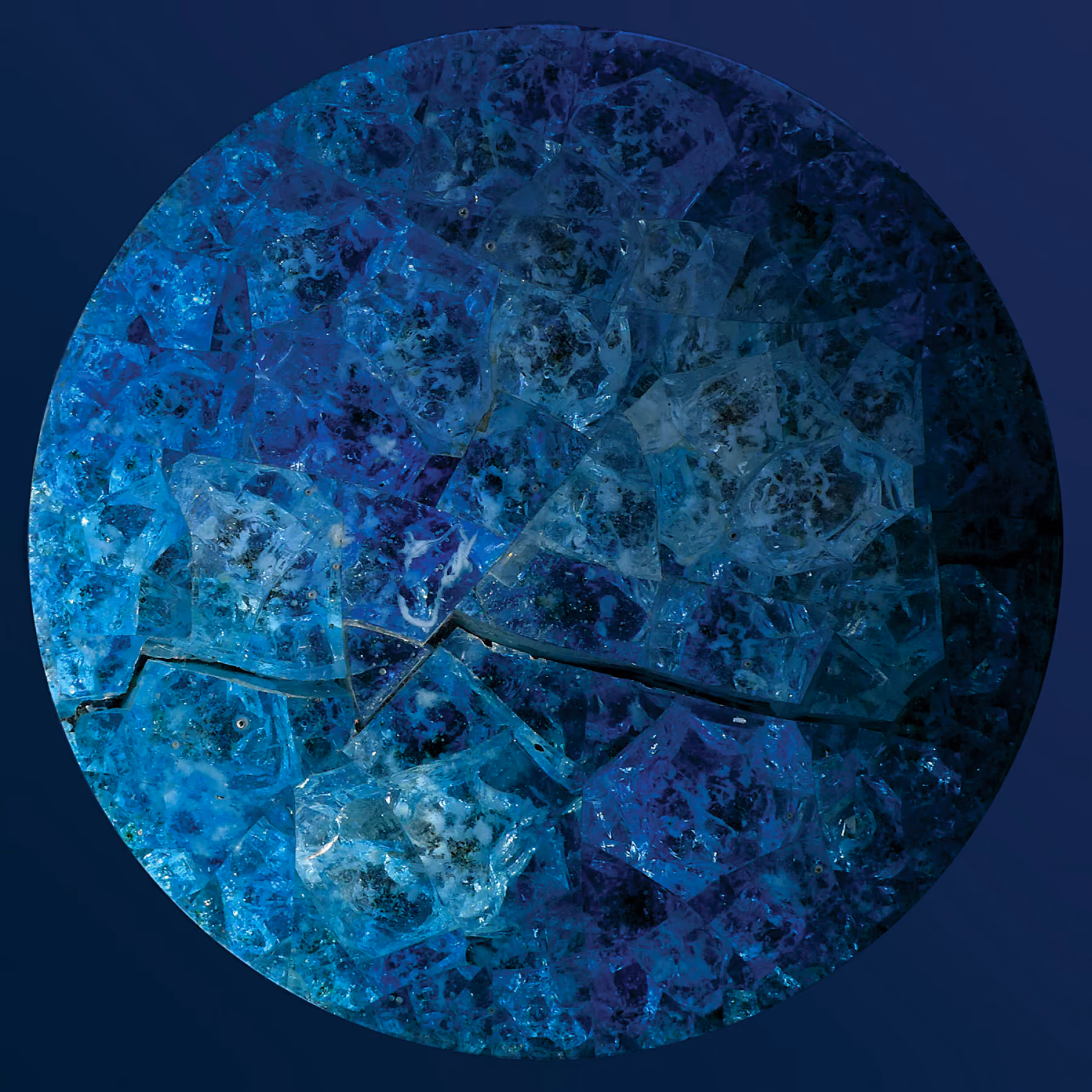 Nabil Gholam Architects' 2014 Christmas greeting card, a circular mosaic of shattered blue and turquoise glass fragments resembling a frozen planet