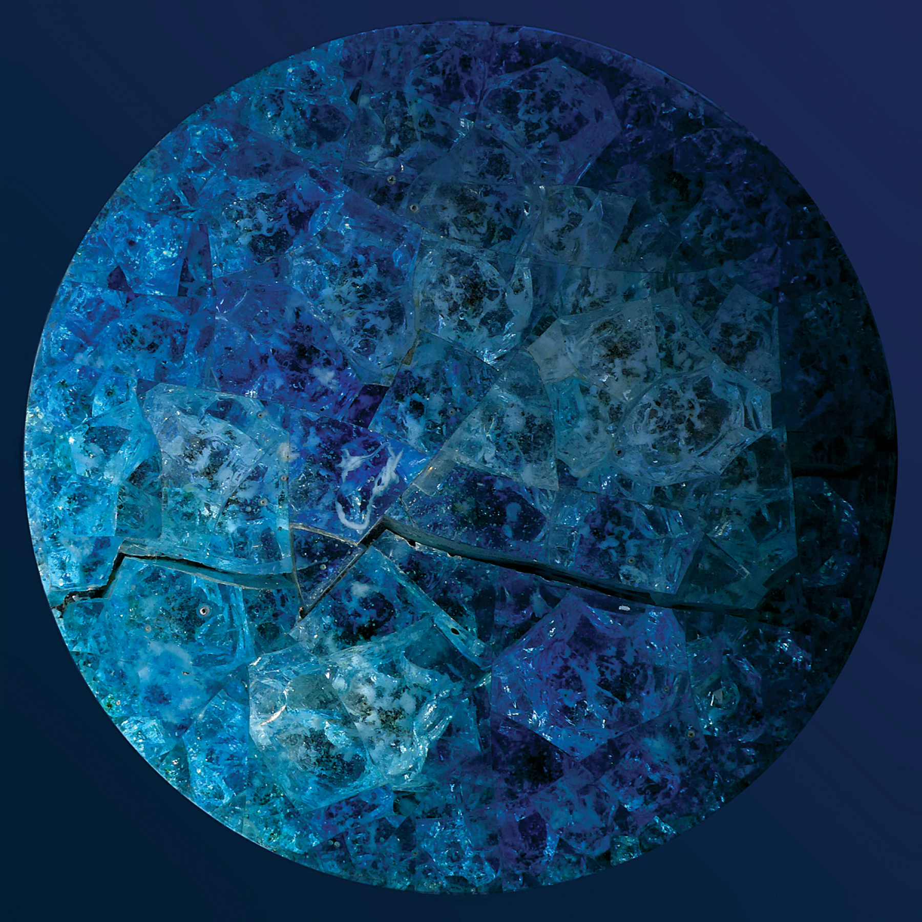 Nabil Gholam Architects' 2014 Christmas greeting card, a circular mosaic of shattered blue and turquoise glass fragments resembling a frozen planet