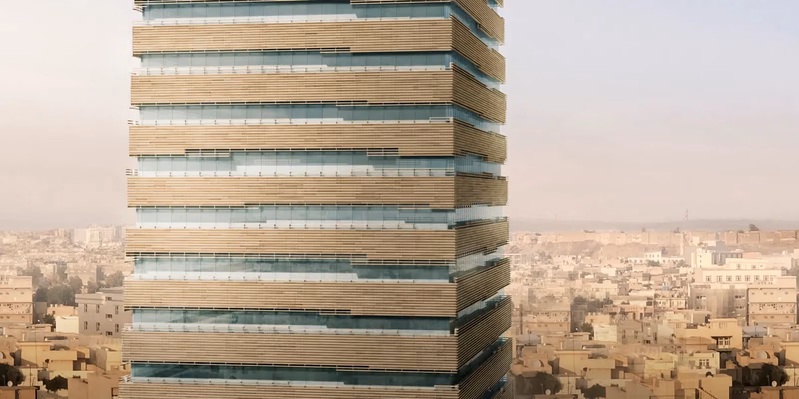 Citadel Tower by Nabil Gholam Architects, a high-rise with horizontal brick-toned brise-soleil bands and glazing, overlooking the dense low-rise cityscape of Erbil, Iraq