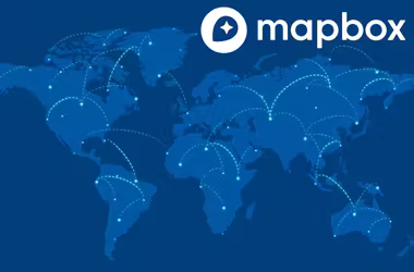 Zoomed-in Mapbox map showing detailed local business markers through MapCosmos integration