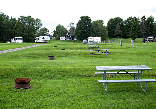 Water and electric RV site with mountain views at Lake Champagne Campground