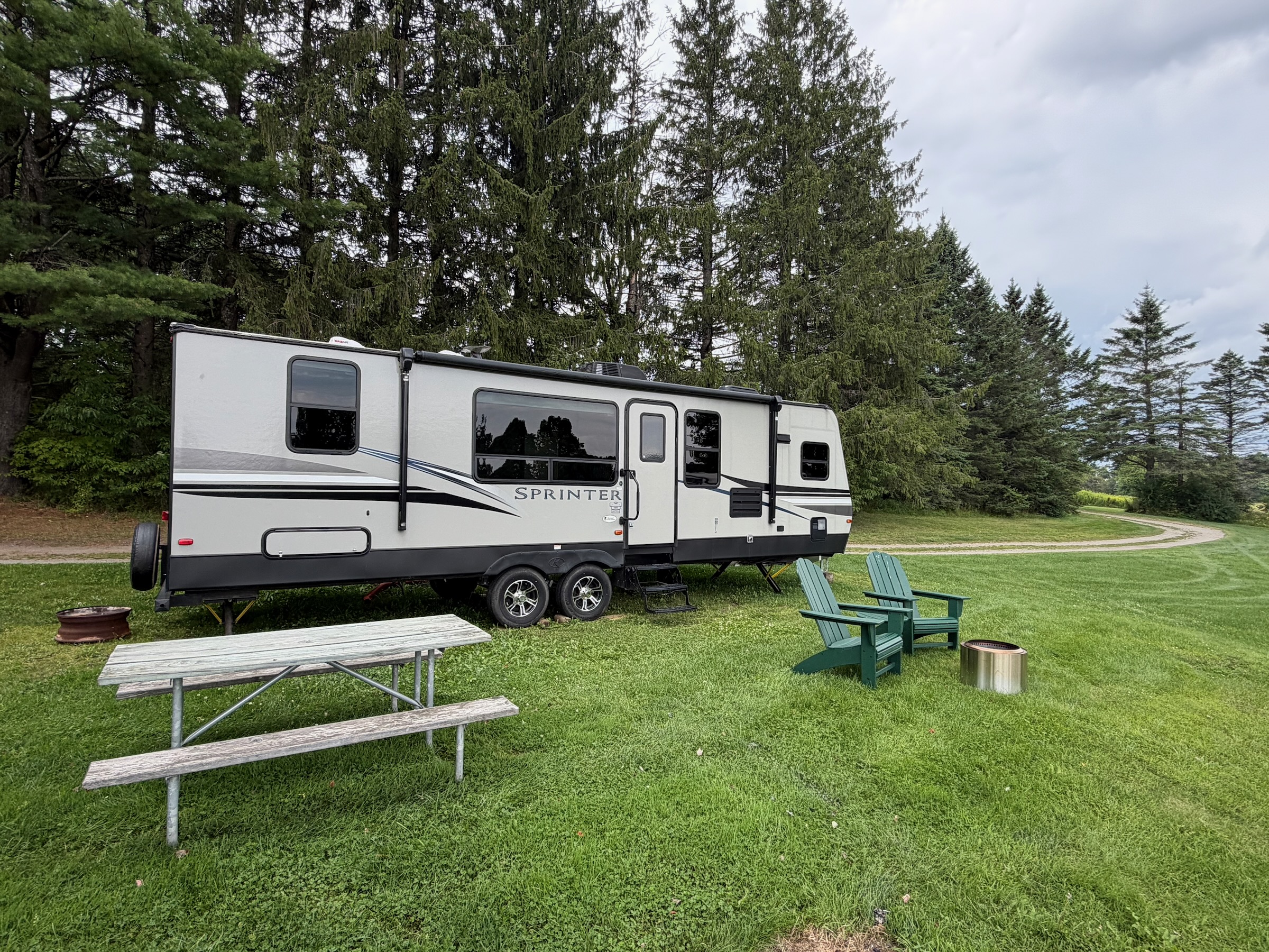 Lake Champagne rental RV at its outdoor site with a picnic table