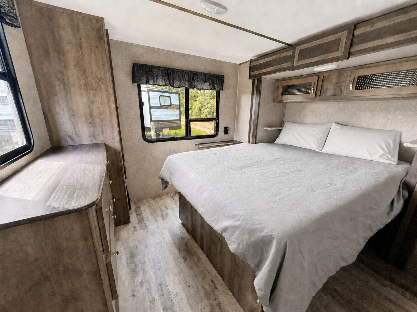 Made queen bed in the rental camper bedroom
