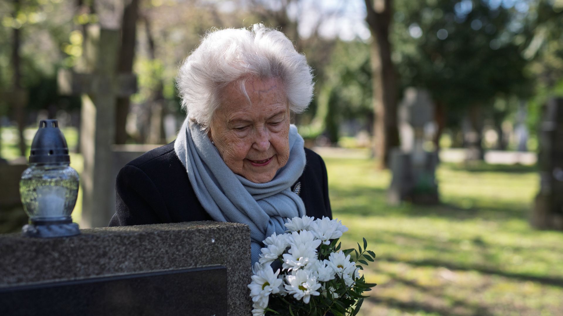 A widow visits the grave of her husband.