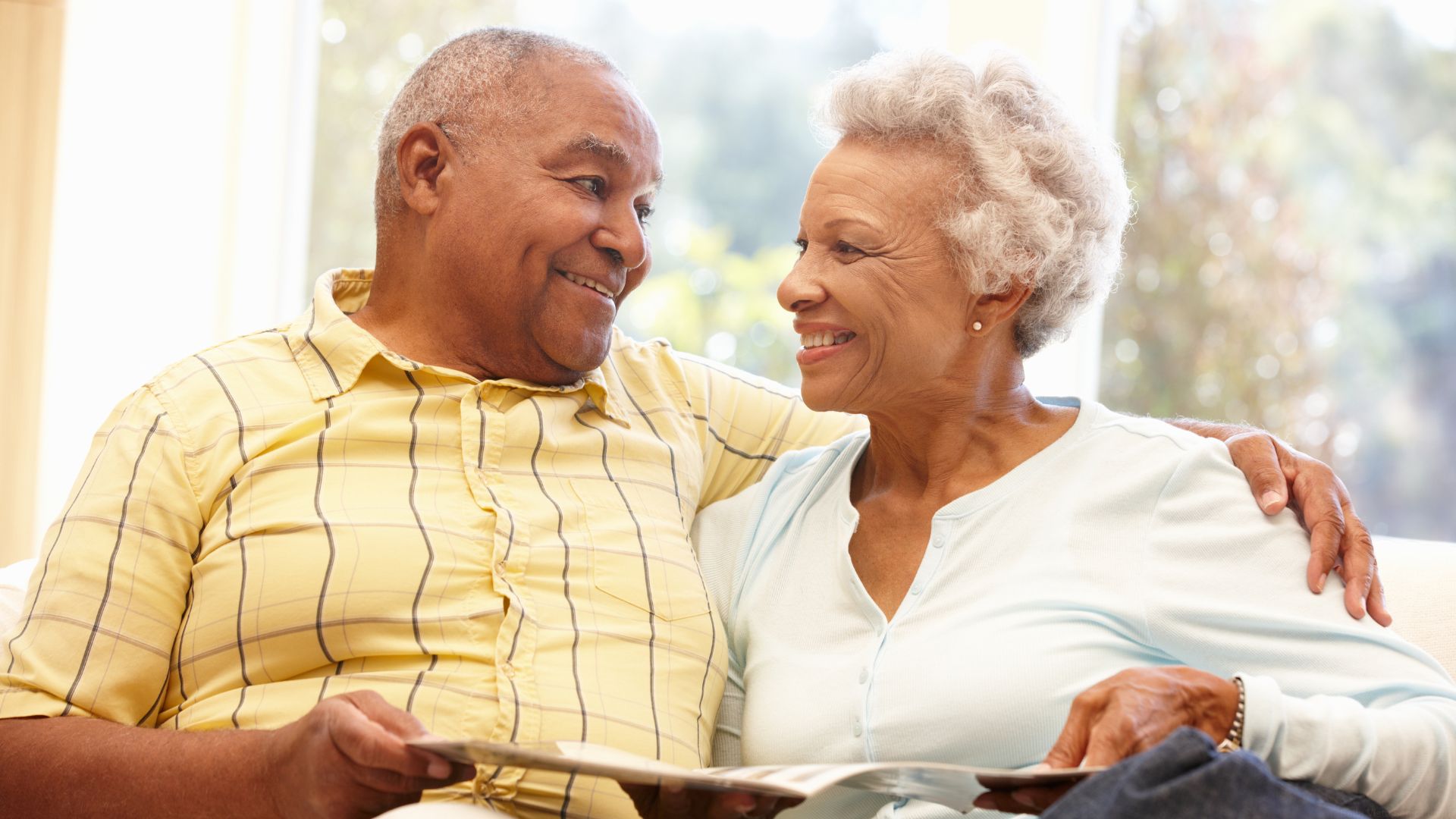 A couple relaxes in senior living, enjoying a maintenance-free lifestyle.