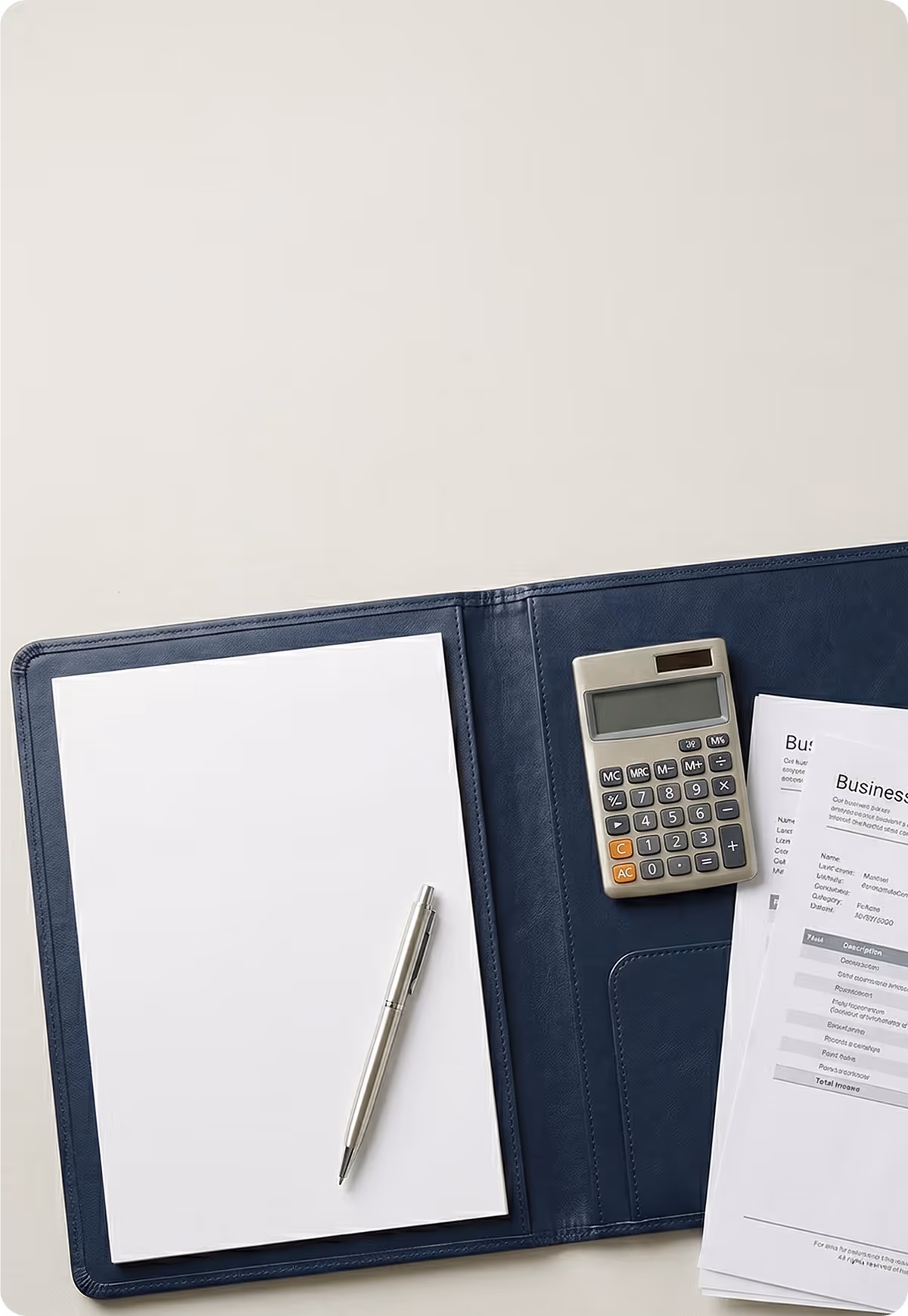 Open blue folder with blank paper and pen on left, calculator and business papers on right.