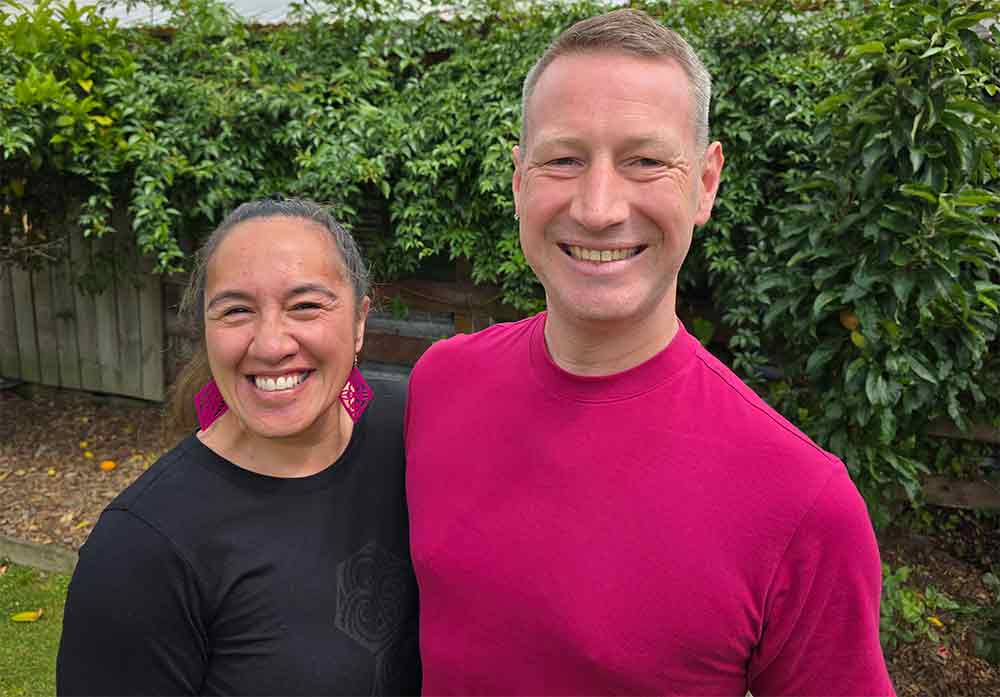 Lisa and Scott smiling wearing pink