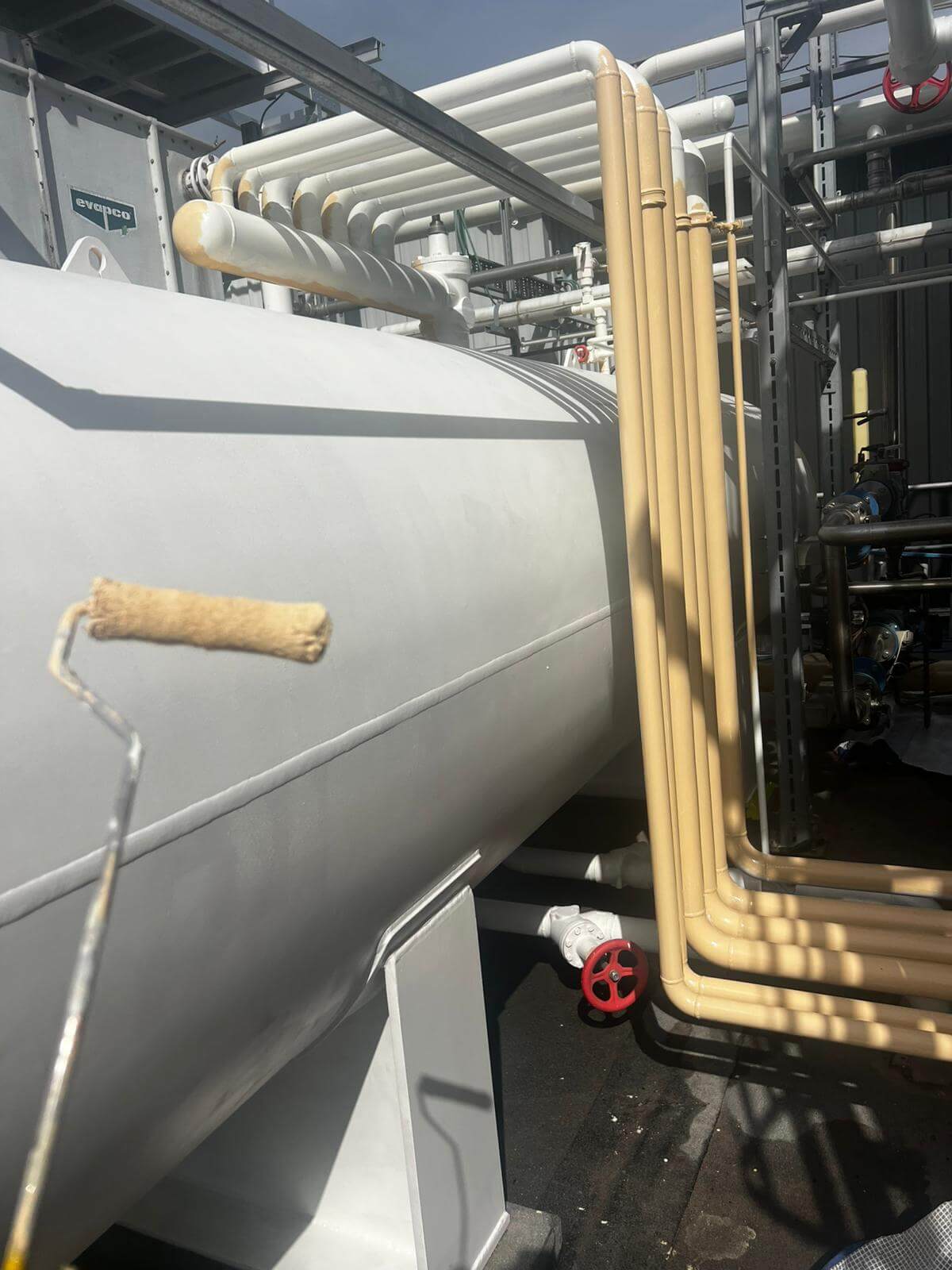 in-progress: maintenance on industrial piping and tank at industrial site