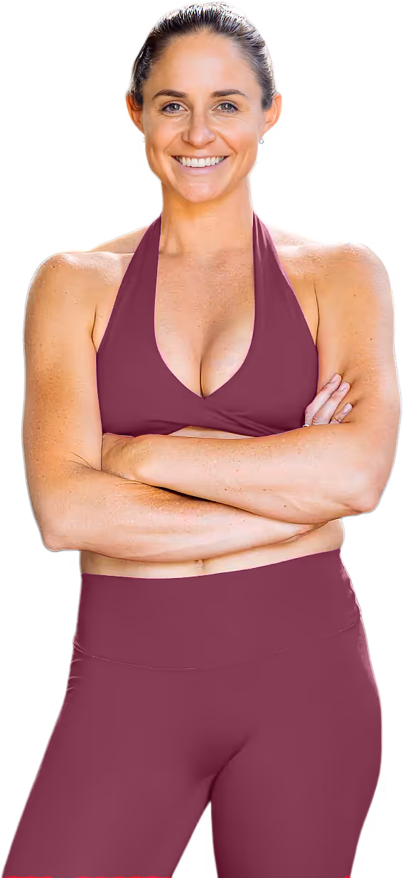 Smiling woman with arms crossed wearing a bright pink sports bra and matching bottoms.