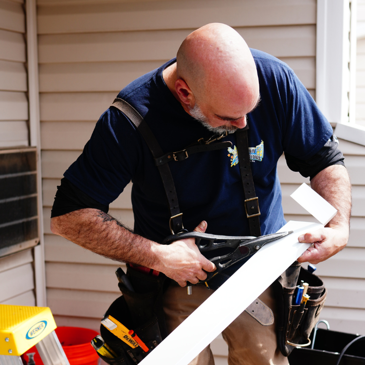 Window Perfections installer preparing replacement window materials in Blair County, Pennsylvania