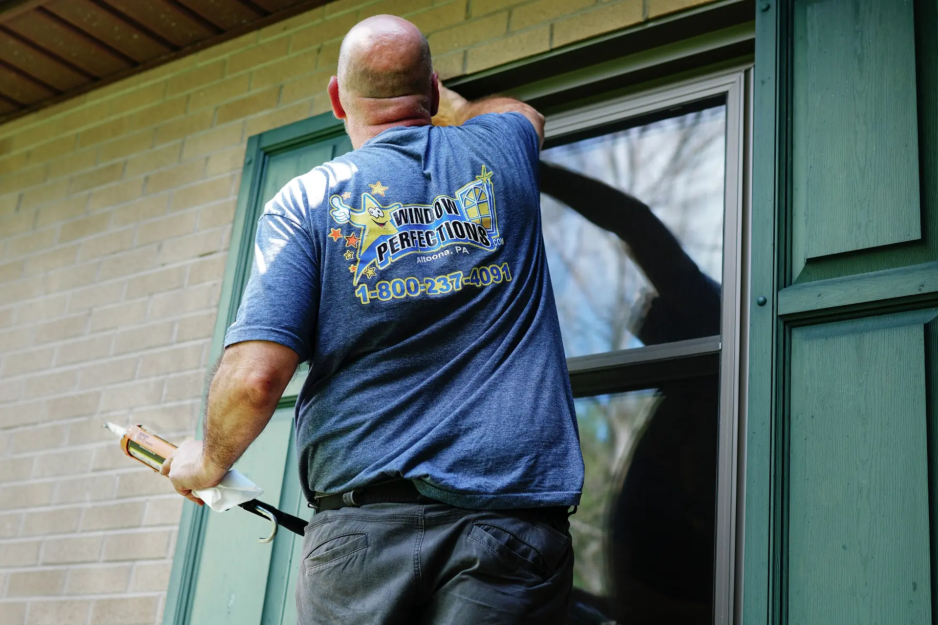 Window Perfections installer working on a home