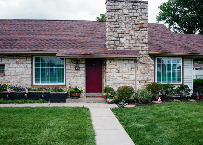 Full home exterior showing two completed picture window installations