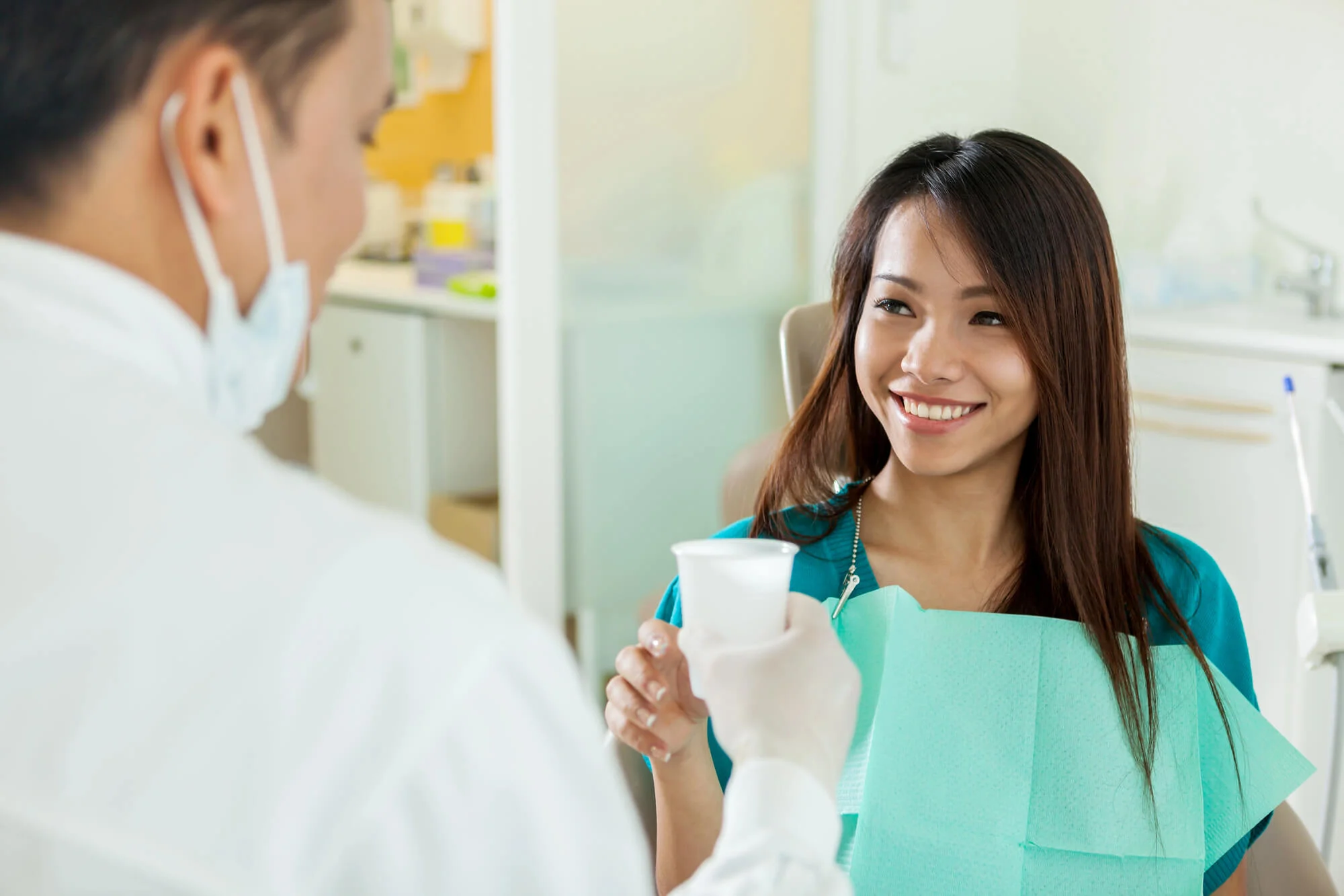 Happy patient with dentist in Grosse Pointe Woods, Michigan.