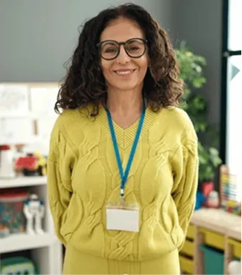 A woman wearing glasses and a yellow sweater.