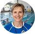 A woman with a stethoscope standing in front of a swimming pool.