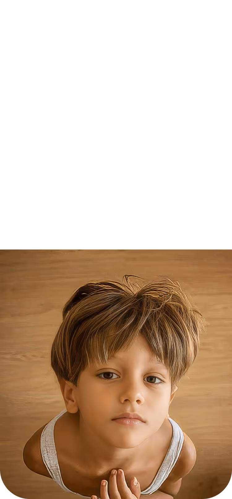 Young boy with tousled light brown hair and white tank top