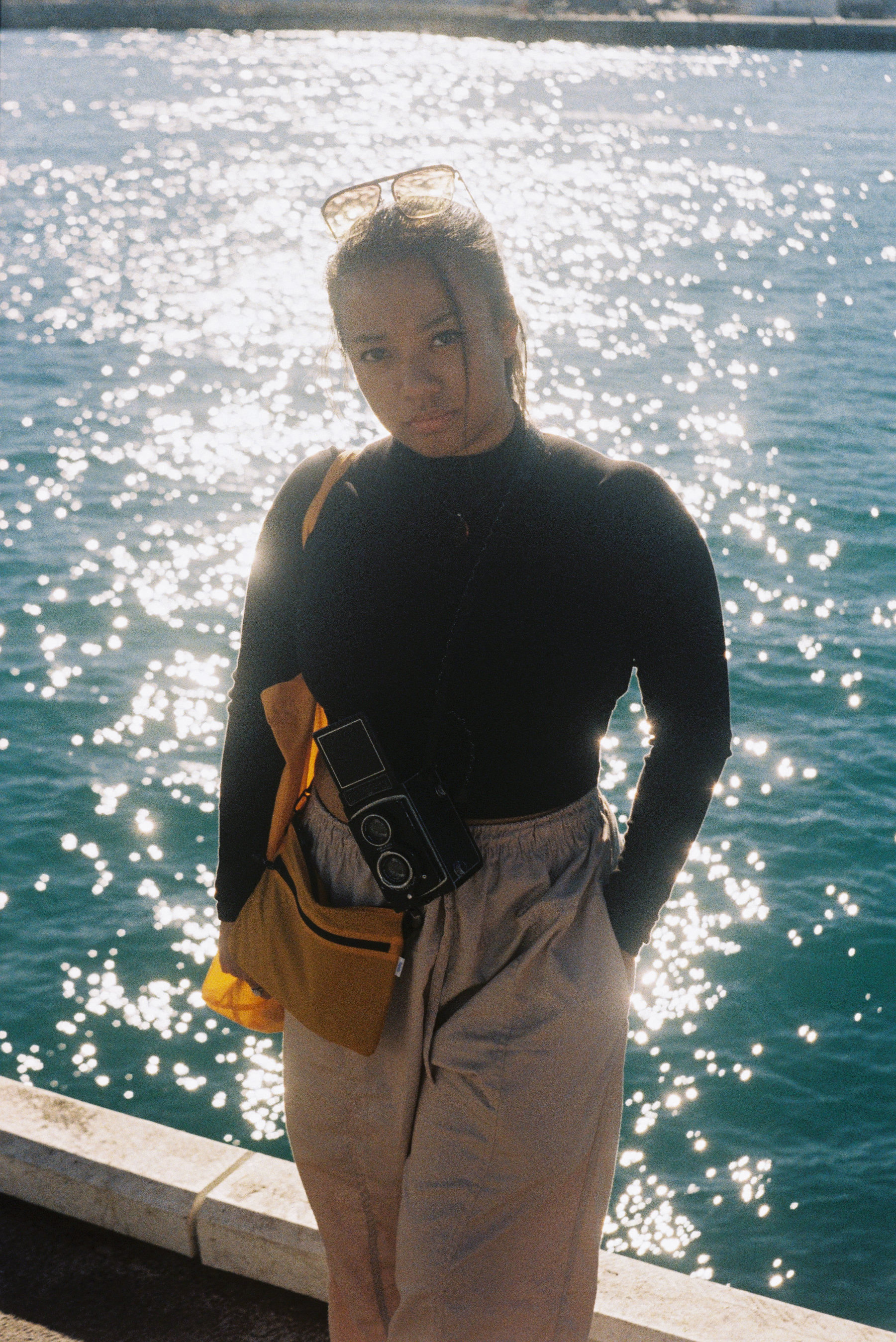 Electus Films founder Ayu. Film photo taken in Fremantle with water in background.