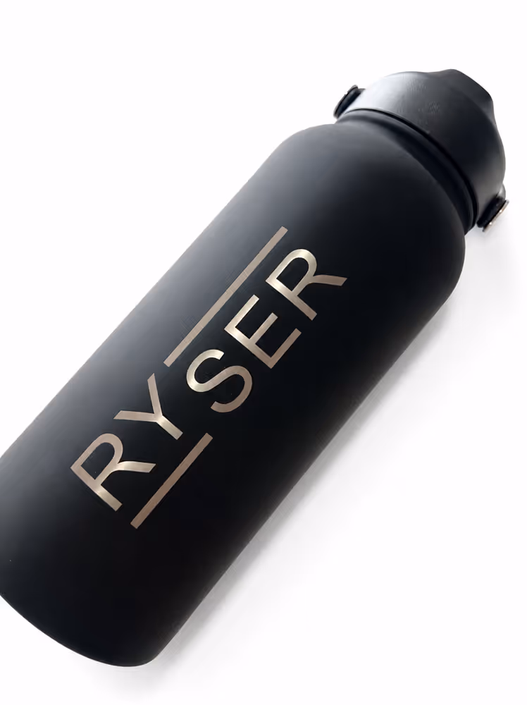 Black water bottle with the brand name RYSER printed vertically in metallic letters.