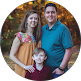 Family of three smiling outdoors in autumn setting, representing trusted local IT support team in Germantown TN