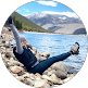 Person relaxing outdoors by mountain lake, representing work-life balance for Germantown TN managed IT services clients