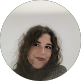 Woman with curly hair smiling, representing friendly IT support team at NET-i managed services Germantown TN