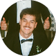 Smiling IT professional in formal attire giving thumbs up, representing NET-i managed services team in Germantown TN
