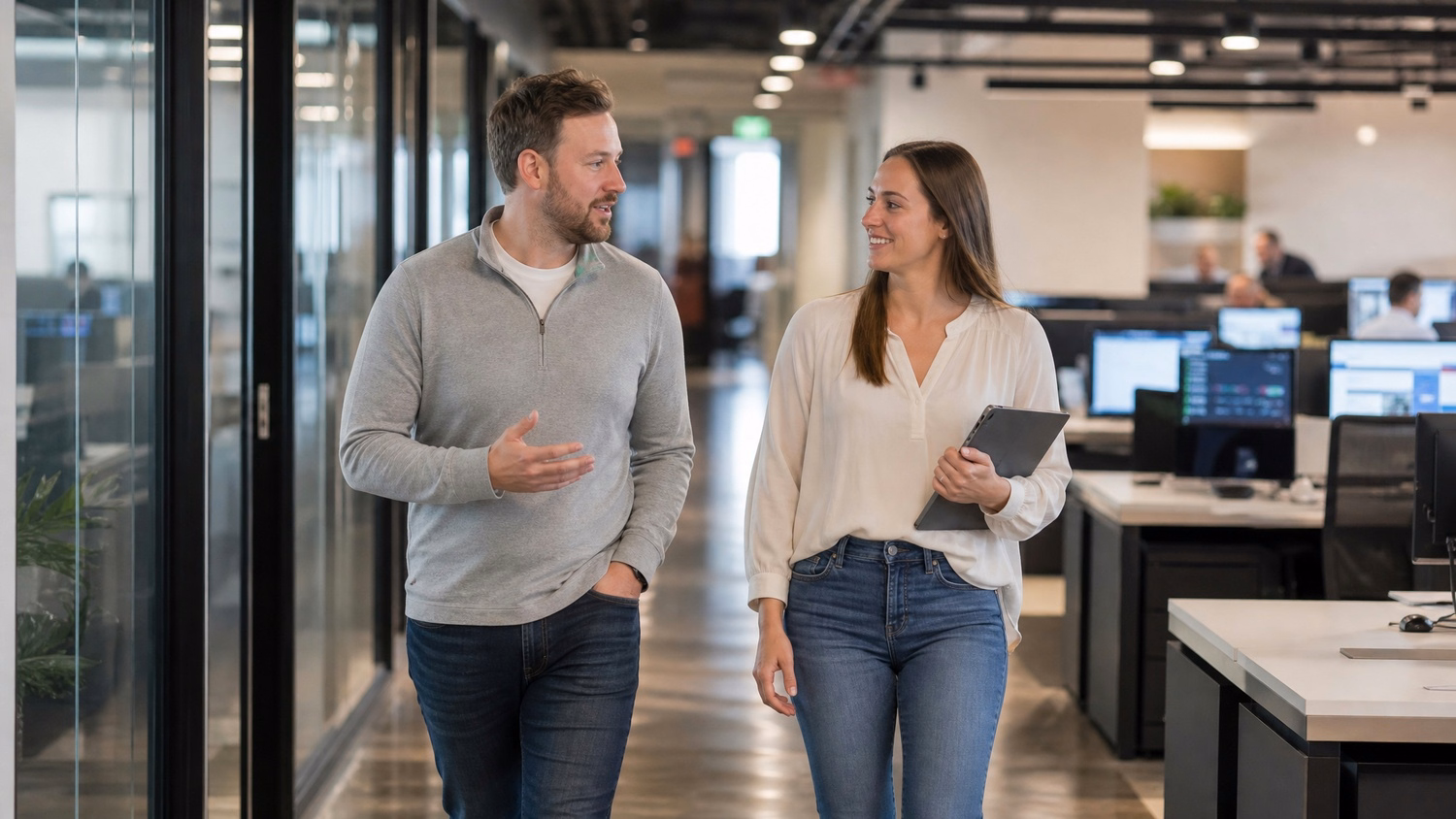 Office colleagues walking and talking mid-stride