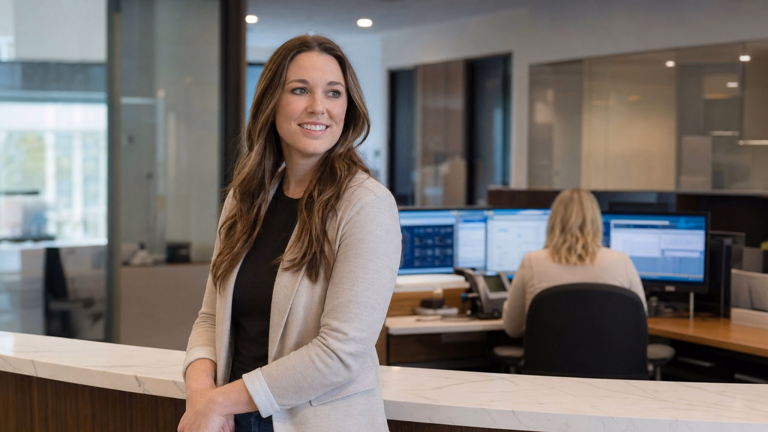 Woman at reception desk reviewing data, IT consulting 64 chars