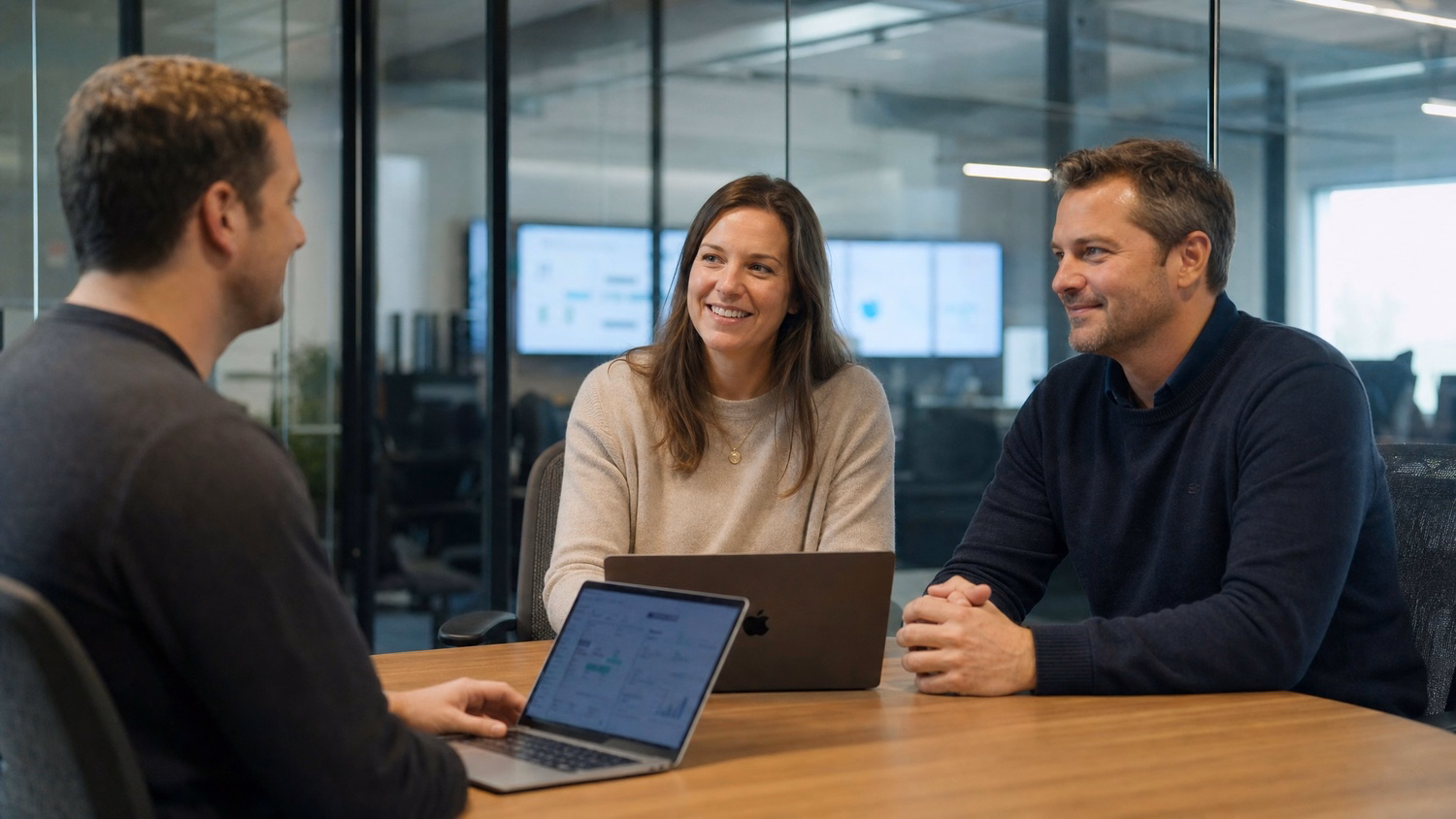 Consultants collaborate around a table in glass conference room 67 chars