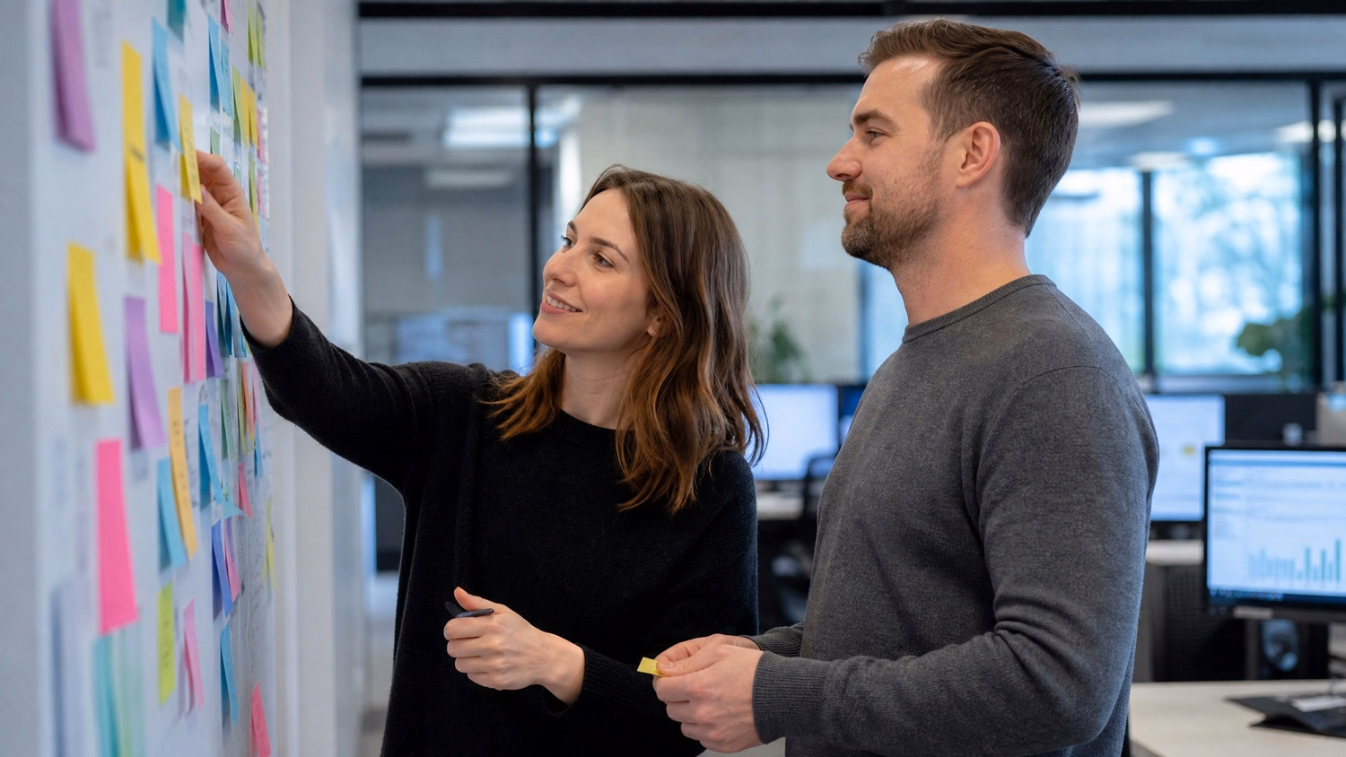 Team brainstorming with colorful sticky notes on wall 38