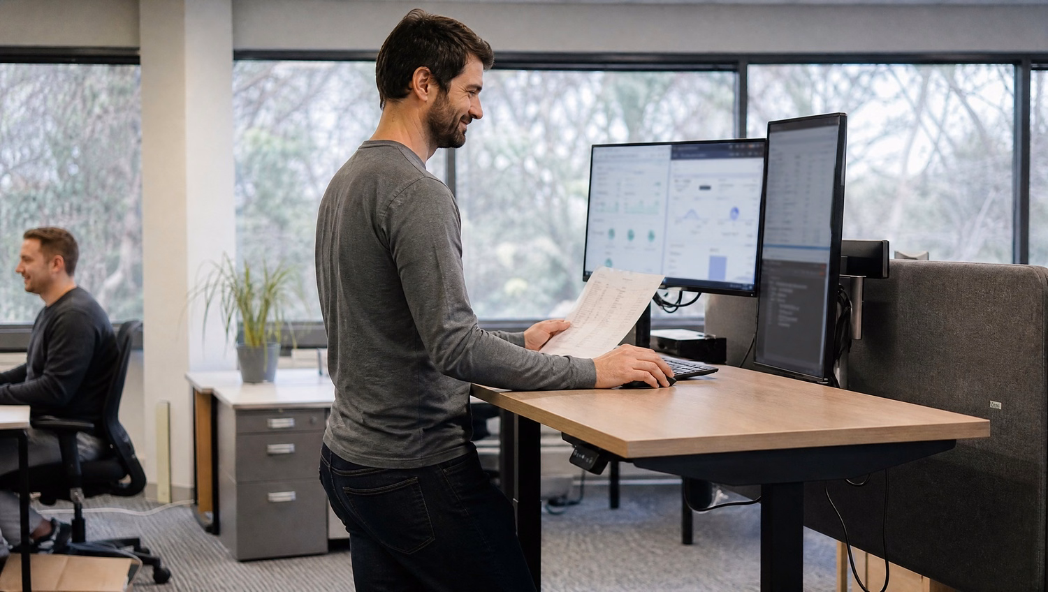 Auditor at standing desk entering system controls data 71 chars
