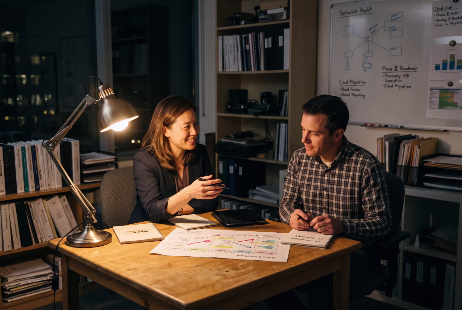 IT management consultant discussing roadmap with team member in office