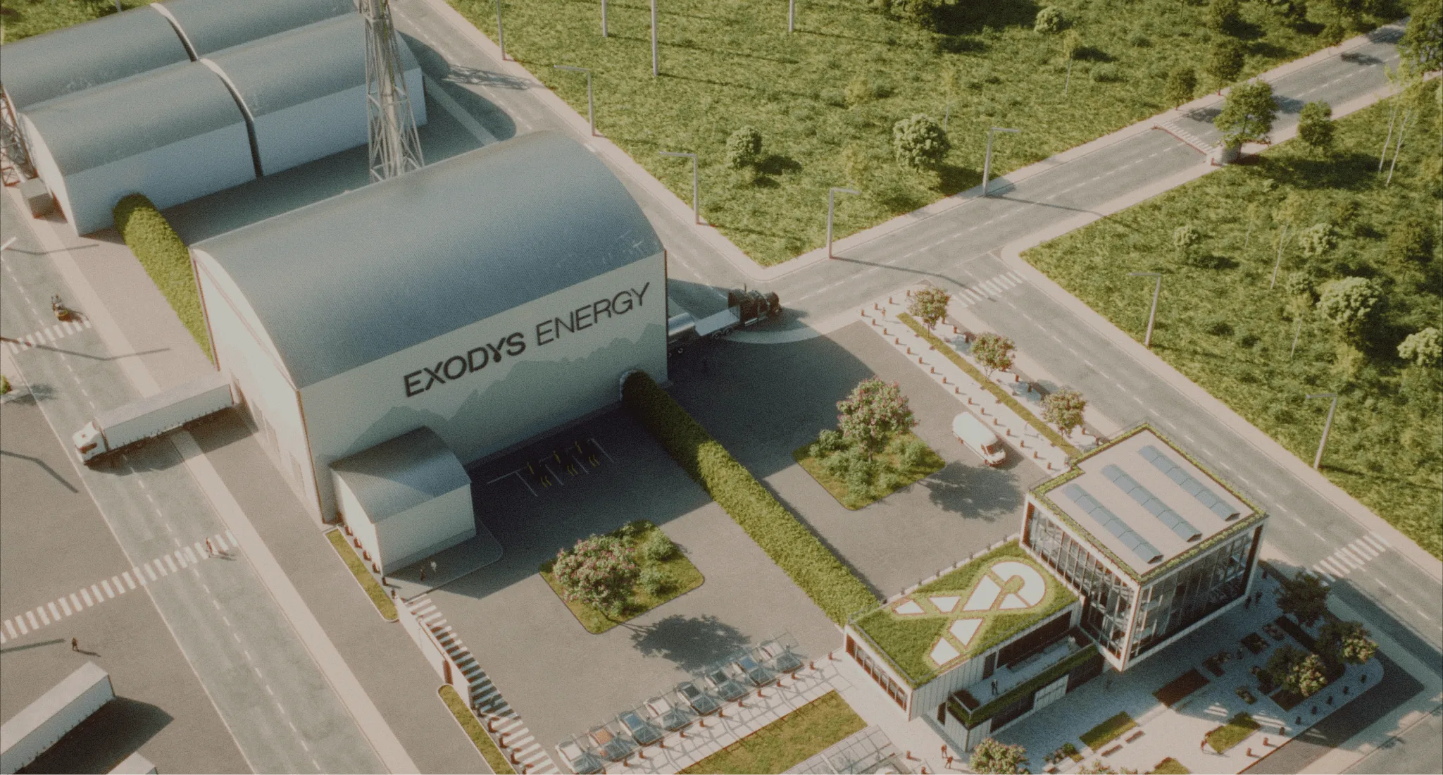 Aerial view of a modern energy facility with buildings, solar panels on a rooftop, green landscaping, and trucks parked nearby under the name 'EXODYS ENERGY'.