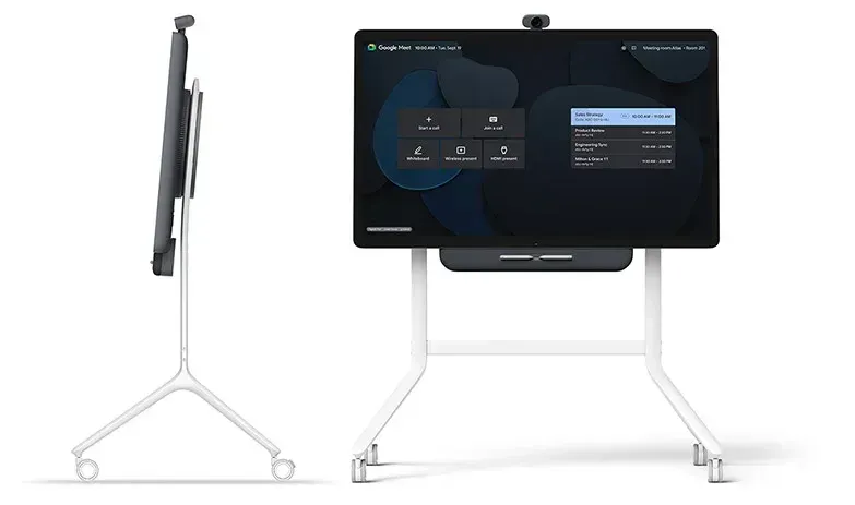 Google Meet Series One Board 65 video conferencing display on white stand with wheels, shown front and side.